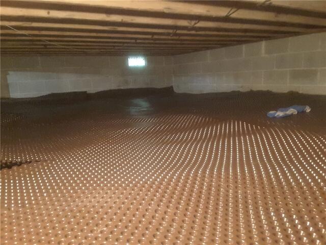 Drainage Matting was laid across the floor in the crawl space to move standing water around with its textured grooves.