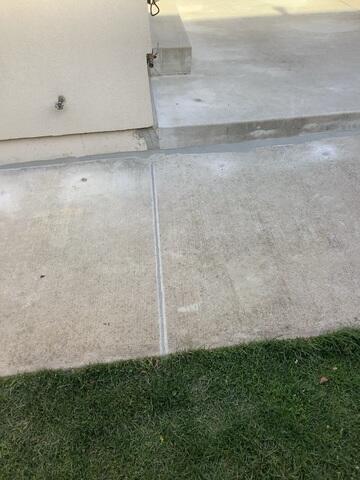 By lifting these side walkway slabs, we eliminated tripping hazards and restored a safe path to the backyard. We then sealed the perimeter against the house to ensure water is directed away from the foundation.