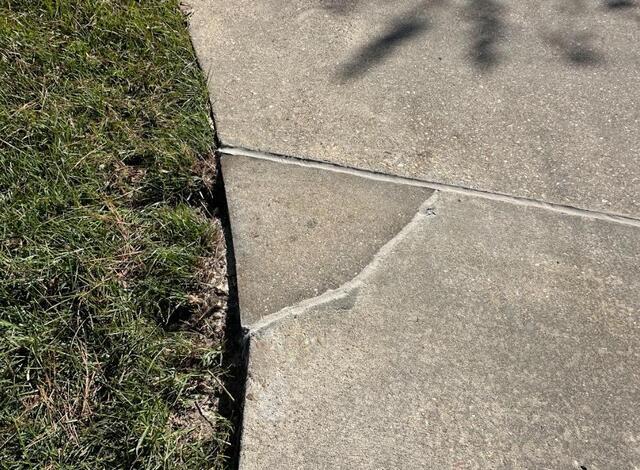 Driveway After Image 1, the concrete section was reconnected, sealed, and leveled.