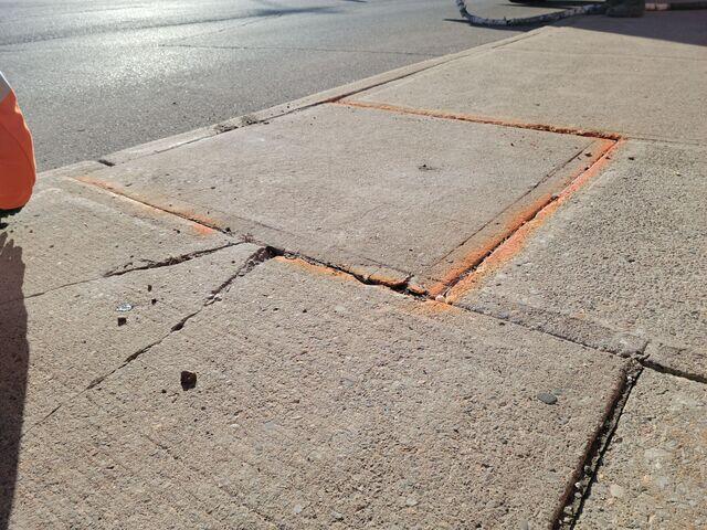 Detail view of the stabilized slab following high-density polyurethane injection. The expanding polyurethane has filled the underlying voids, providing structural support and eliminating the previous height discrepancy.