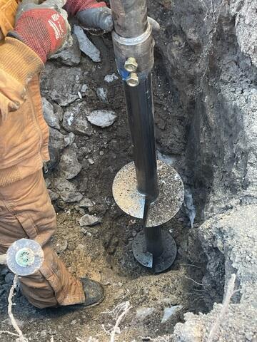 During: Our Foreman, Gabriel, and his crew replaced the struggling post with a Helical Pier.