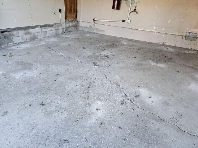 This wide view shows the total extent of the slab failure across the garage. It identifies the uneven "islands" of concrete that require PolyLevel® injections to lift the floor back to its original, safe grade.