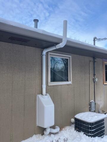 After: Our Foreman, Dakota, and his crew successfully secured the Radon Mitigation System outside the home.