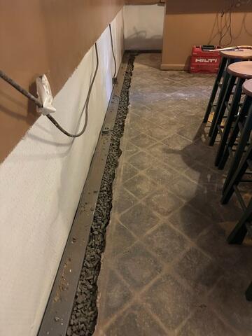 WaterGuard was installed around the perimeter of the basement to direct any seeping water to the sump pump for removal.