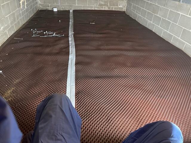 During: Our Foreman, Jesus, and his crew secured Drainage Matting on the crawl space floor.