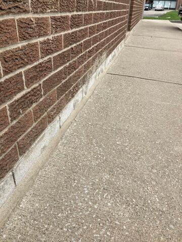 The completed sealant application along the building's perimeter provides a clean, professional finish. This flexible barrier accommodates natural concrete movement while keeping the sub-base dry and secure.