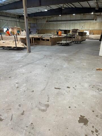 In a busy truss manufacturing facility, a level floor is essential for safety and efficiency. These long, linear cracks show where the slab has lost support, disrupting daily operations and creating a dusty, uneven work environment.