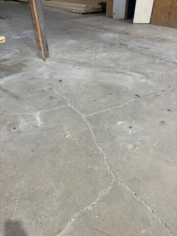 Structural cracks and uneven "lips" across the slab create significant tripping hazards and hinder the movement of heavy carts. These surface issues are the first signs of settling caused by hollow voids beneath the concrete.