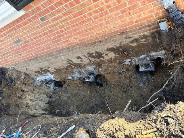 This photo was taken after we screwed all three piers straight down underneath the home and attached our brackets to transfer the weight of the home.