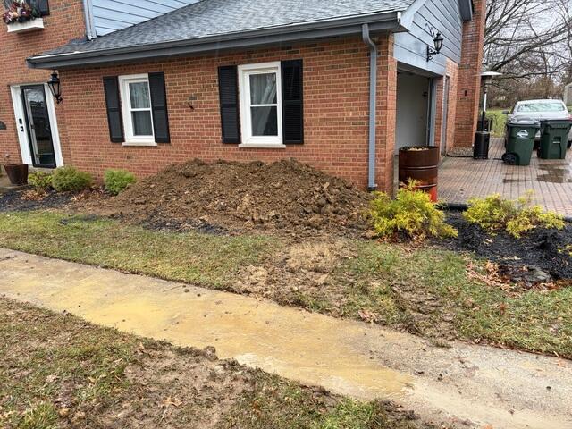 This photo was taken after we covered the piers with dirt. We like to show these "final" photos to be transparent with our customers on how it may look afterwards. Overtime, this pile of soil should settle back down with some rain.