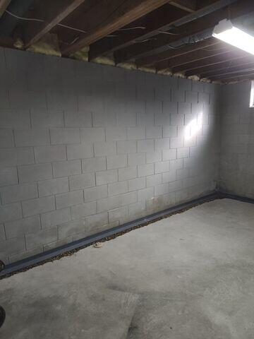 During: Our Foreman, Lane, and his crew secured WaterGuard around the basement perimeter.