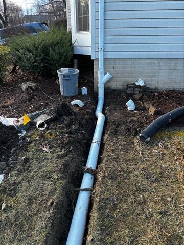 Downspout extension being installed