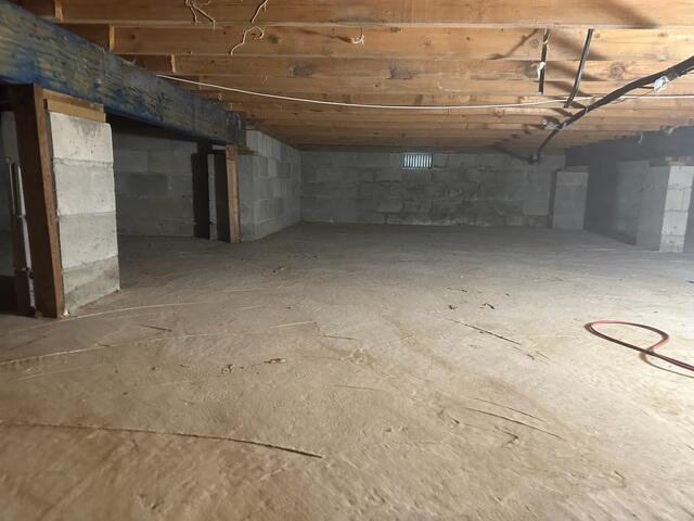 The state of the crawl space before our team tackled the encapsulation project. The space was damp and unsealed.