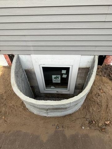 During: Our Foreman, Aaron, and his crew secured two egress windows on the struggling wall.