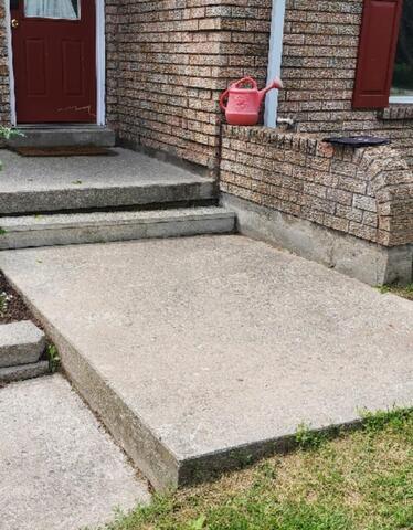 The overhead view shows the strategic access points drilled into the concrete. These small ports allow the structural polymer to be injected into the hollow cavities, ensuring a controlled and even lift of the heavy slab.
