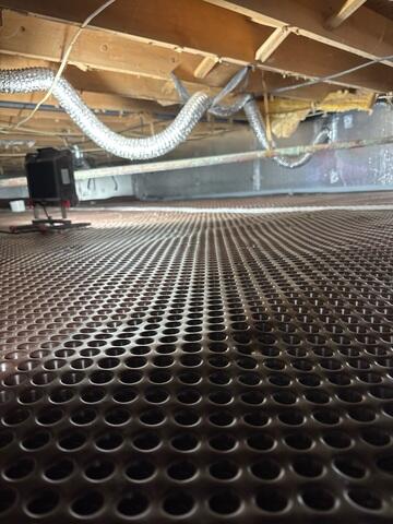 Drainage matting was laid across the floor to move any standing water to the sump pump for removal.