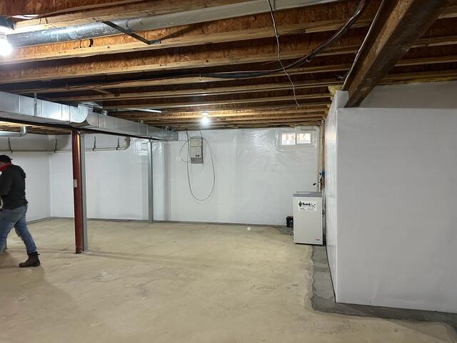The basement after waterproofing, featuring CleanSpace-lined walls and a fully installed TripleSafe system, creating a clean, dry, and protected space.