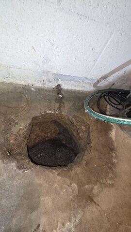 Before: The homeowner knew it was time to replace their out-of-date sump pump.