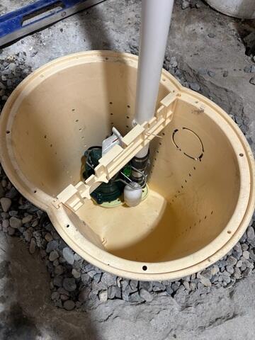 During: The crew took out the old sump pump and replaced it with the TripleSafe sump pump.