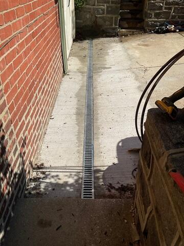 By quickly channeling water into the drainage system, TrenchDrain provides an added layer of defense and helps keep the basement dry and usable during heavy rain events.