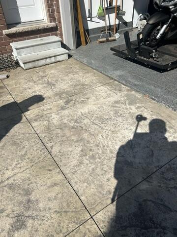 Visible "ghosting" spots and large gaps where the slabs have shifted away from the foundation, leading to poor drainage and trip hazards.