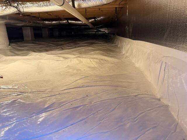 Our CleanSpace Vapor Barrier System was installed to fully encapsulate the crawl space and block moisture from the ground and outside air. This durable, reinforced liner creates an effective seal that prevents water vapor from rising into the crawl space, reducing humidity levels and improving overall air quality.