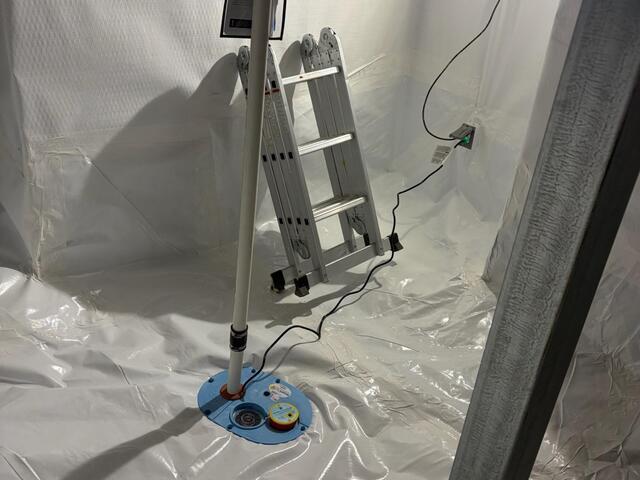 This photo shows our SmartSump sump pump. It has an airtight lid, and was designed to be fitted with our vapor barrier to create a seal. The sump pump also has an airtight floor drain and an alarm system to account for potential plumbing leaks in the space. All of our patented products serve a purpose, and they work in cohesion with one another.