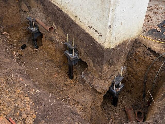 Here is a close up of the piers. The tops of the piers have our "L" shaped brackets attached to them, which allows us to latch them up underneath the footing of the garage, making for a secure system.