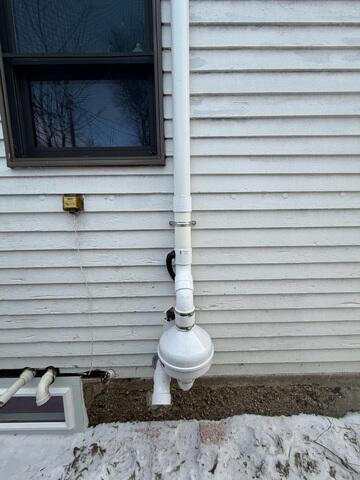 During: Our Foreman, Dakota, and his crew secured the Radon Mitigation System outside of the home.