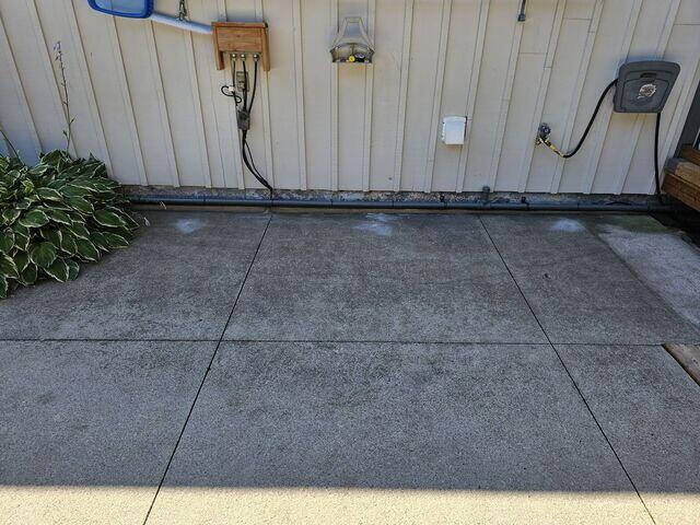 The "After" shot of the utility area. These slabs are now flush with the wall and the surrounding deck, creating a seamless, trip-free path to the pool equipment.