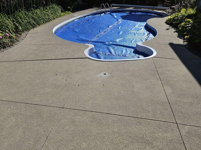 The recessed slab in front of the walkway has been lifted to meet the existing grade, restoring the safety and beauty of the entire poolside oasis.