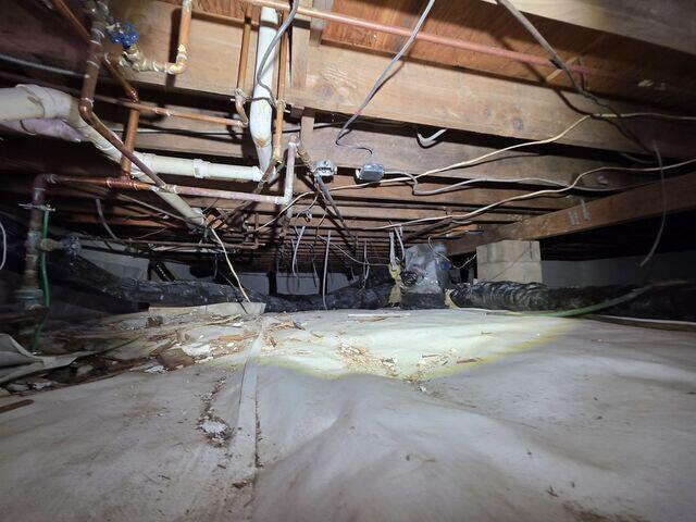 The state of the damp crawl space before the project.