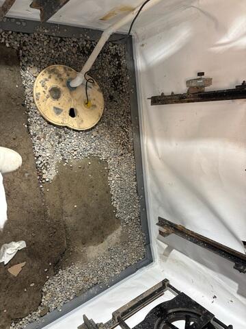 During: Our Foreman, Nanga, and his crew secure the products in the corner of the elevator shaft.