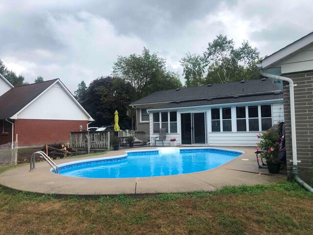 This image shows a major vertical gap where the deck has settled away from the pool coping, creating a dangerous trip hazard in a high-traffic area.