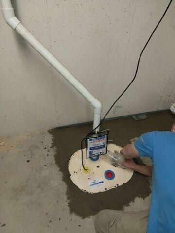 Installer installing Triple Safe Sump Pump