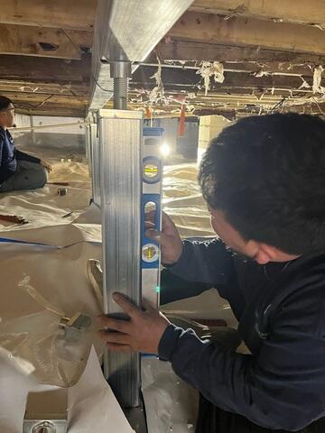 Installation Crew installing the smart jacks and supplemental beams to support the floors and replace the rotted wood beams. The smartjacks will also be wrapped with Clean Space vapor barrier.