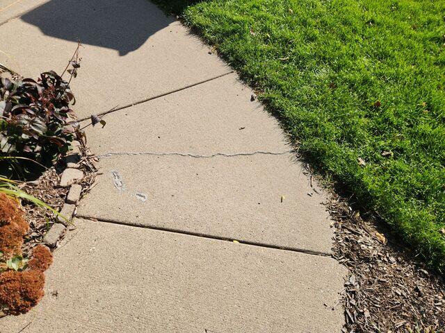 Before: Our Design Specialist, Dave, suggested lifting the sidewalk using PolyLevel.