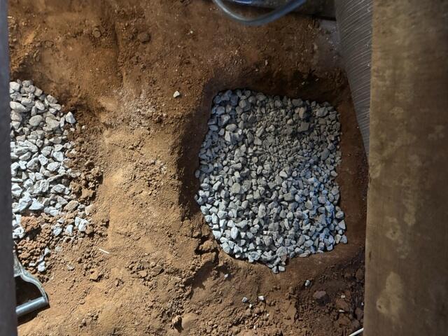 We then backfilled the holes with limestone to make for a sturdy base. Unlike wet soil, limestone won't settle over time.