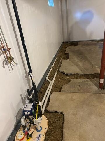 During: In addition to the new sump pump, our Foreman, Matt, and his crew secured several waterproofing products throughout the basement.
