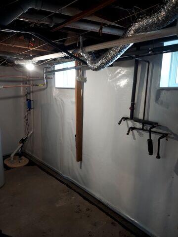 During: Our waterproofing crew worked hard to secure the waterproofing products throughout the basement.
