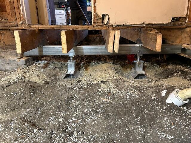 During: Our Foreman, Jose, and his crew secured seven Helical Piers below the sinking foundation.