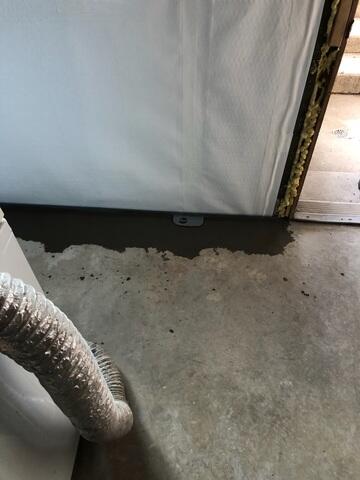 Close-up view of basement drain installation in Clearfield, UT showing perimeter waterproofing system designed to redirect water and relieve hydrostatic pressure.