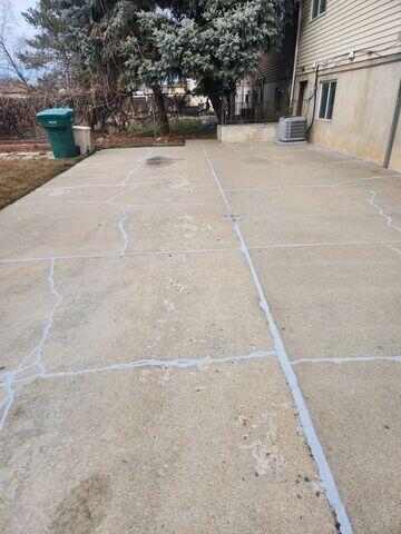 Exterior concrete cracking at a Clearfield, Utah home showing signs of foundation settlement. Structural movement beneath the footing required push pier installation and foundation stabilization.
