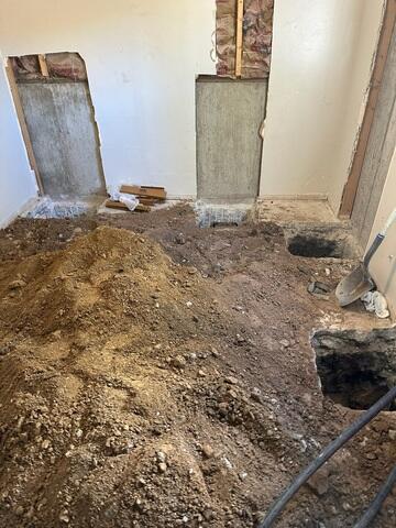 Multiple excavation points prepared inside this Clearfield, Utah basement for the installation of 9 push piers to permanently stabilize foundation settlement.