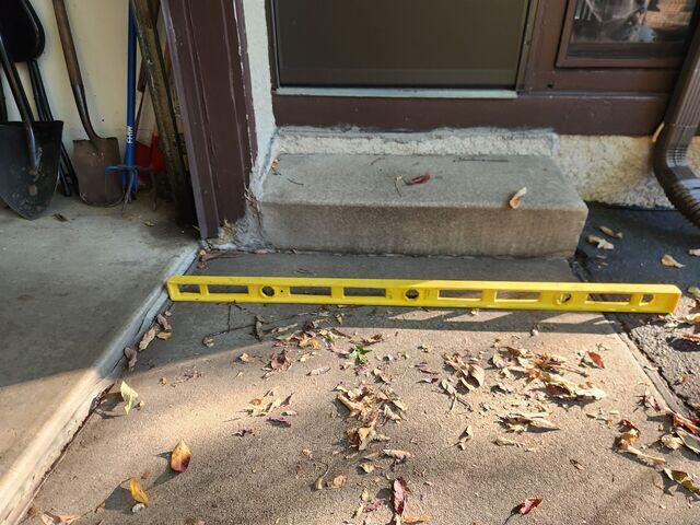Before: Our Design Specialist, Dave, recommended lifting the sidewalk back into place.