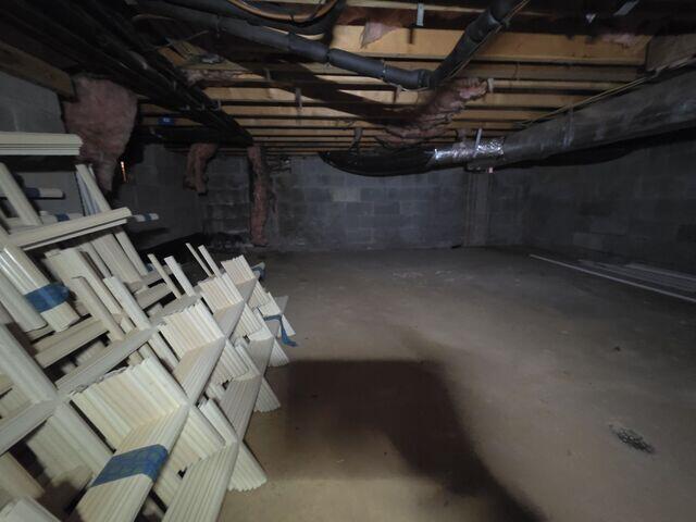 Damp crawl space in Towson, MD with exposed floors and high humidity allowing moisture to spread throughout the home.