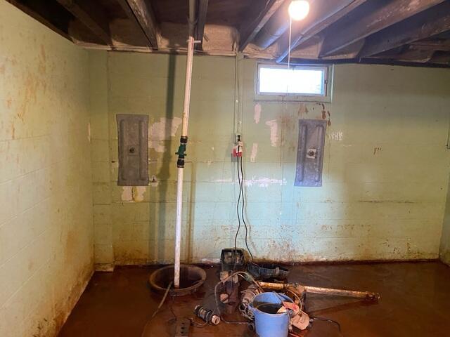 Before: Mac, our Design Specialist, is securing waterproofing products throughout the basement.