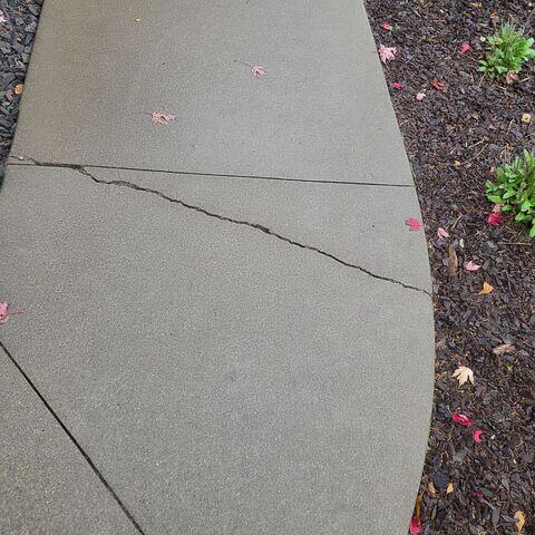 Before: Our Design Specialist, Brad, and his crew recommended repairing the cracks and lifting the damaged concrete.