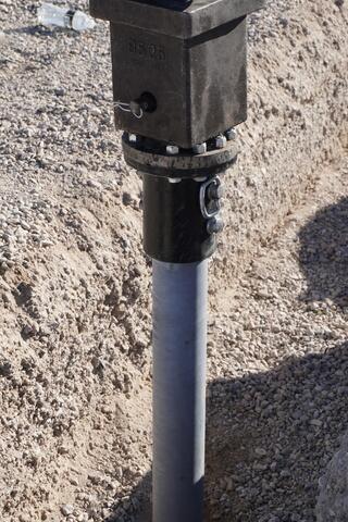 Installation of a production helical pier using a high-torque hydraulic drive system. The pier advances through liquefiable fine-grained silt clays to reach stable load-bearing strata beneath the structure.