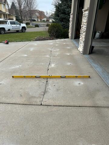 During: Our Foreman, Ryan, and his crew lifted the slabs back to their original level.